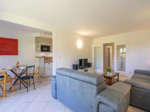 a living room with a couch and a table at Apartment Résidence de Mons by Interhome in Royan