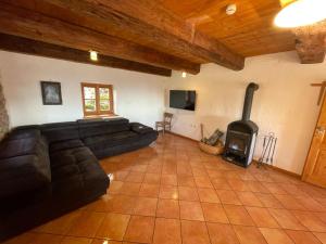a living room with a couch and a wood stove at Kas Alm am Grandsberg in Schwarzach