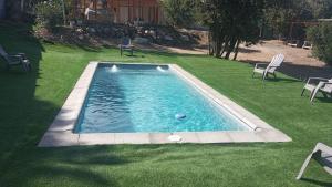 a swimming pool in the middle of a yard at Refugio el Amparo de Paine in El Majuelo +10 photos