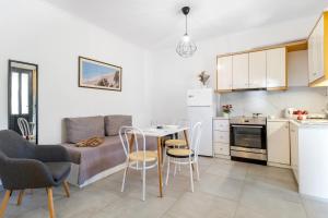 a small kitchen with a table and chairs in a room at Dionysia Rooms in Lefkada +40 photos