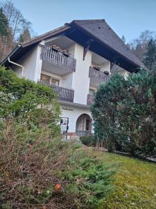 a large white house with a balcony at Triberg Falls Hideaway - Apartment 35 in Triberg