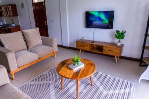 a living room with a couch and a coffee table at Timeless Stays in Arusha