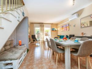 a dining room and living room with a table and chairs at Holiday Home Boters-2 by Interhome in Torredembarra
