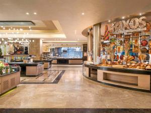 a shopping mall with a bakery with a lot of food at Rixos Premium Seagate in Sharm El Sheikh