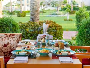 a table with plates of food on top at Rixos Premium Seagate in Sharm El Sheikh