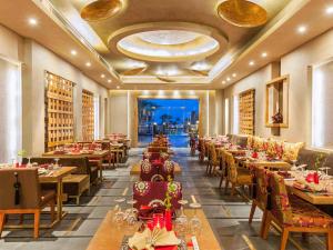 a dining room with tables and chairs and a room filled with tables and chairsktop at Rixos Premium Seagate in Sharm El Sheikh