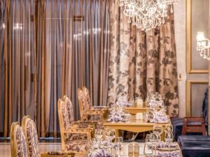 a dining room with a table and chairs and a chandelier at Rixos Premium Seagate in Sharm El Sheikh