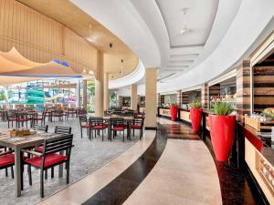 a restaurant with tables and chairs in a building at Rixos Premium Seagate in Sharm El Sheikh