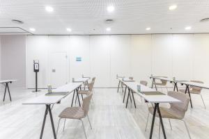 a room with tables and chairs and a podium at Sercotel JC1 Murcia in Murcia
