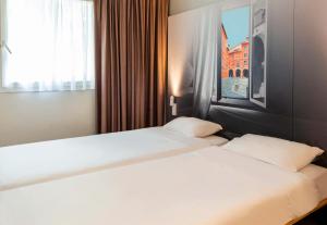 Postel nebo postele na pokoji v ubytování B&B HOTEL Montauban