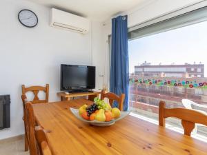 a dining room table with a bowl of fruit on it at Apartment Vaixell by Interhome in Miami Platja
