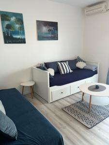 a living room with a couch and a table at Apartments Akiki in Karlobag