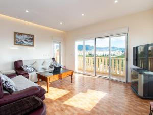 a living room with a couch and a table at Villa Cerro de Mariote by Interhome in Almuñécar +38 photos
