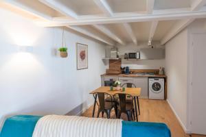 a small kitchen and dining room with a table and chairs at Repos et Sérénité in Lagnieu