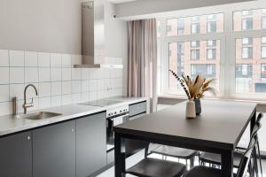 a kitchen with a table and chairs and a window at MIAMI House in Hamburg +16 photos