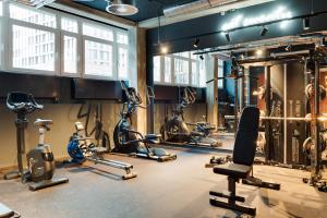 a gym with several treadmills and exercise bikes at MIAMI House in Hamburg
