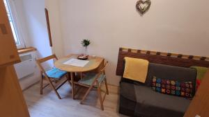 a small room with a table and a couch at White Nest in Pécs