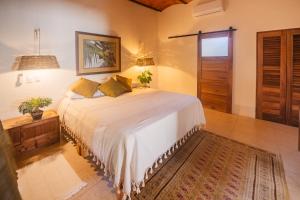 a bedroom with a large bed in a room at Casa Botanica in Lo de Marcos