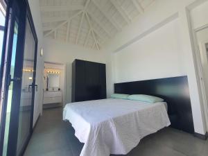 a bedroom with a large bed in a white room at Casa Fielato in Los Barros +9 photos