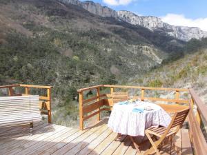 a table on a deck with a view of a mountain at La Sauvanière in Menée