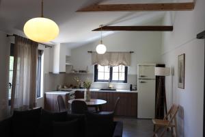 a kitchen and living room with a table and a refrigerator at ALFIEA HOME 65m2 & ALFIEA STUDIO 35m2 in Artemida