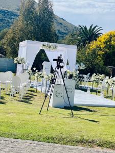 a camera on a tripod in front of a tent at Ndaba Golf Lodge & Hello Beautiful Day Spa in Queenstown