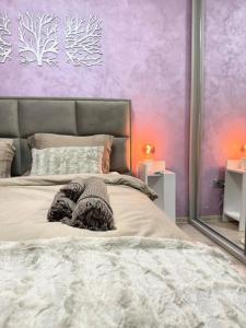 a bedroom with a large bed with a purple wall at Elegant Old Town Escape in Bucharest