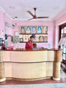 a man sitting at a bar in a restaurant at Maruthi Residency in Puducherry +8 photos