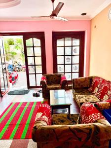 a living room with couches and a table at Maruthi Residency in Puducherry