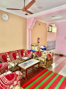 a living room with couches and a table at Maruthi Residency in Puducherry