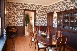 a dining room with a table and chairs at Historic Manor Overlooking Park in Bloomington