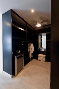 a room with a sink and a robe hanging on a wall at Solaris Beach House - Beachfront Property, St James in Saint James