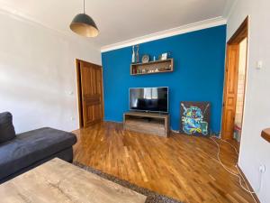 a living room with a blue accent wall at Rio Apartment Old Town Sarajevo in Sarajevo +9 photos