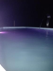 a close up of a swimming pool at night at Chale brilho do sol in Visconde De Maua
