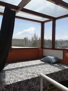 - une chambre avec un lit en face d'une fenêtre dans l'établissement La Casa Junto Al Rio, à Arequipa