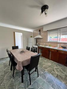 a kitchen with a table and chairs in a room at Casa en alquiler temporario in Ramallo