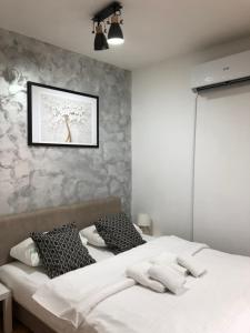 a bedroom with two beds and a picture on the wall at Danijela & konak in Zlatibor +35 photos