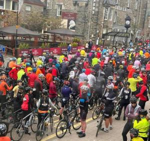 a large group of people riding bikes down a street at Alba Apartment Central Pitlochry in Pitlochry