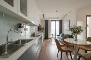 a kitchen with a sink and a table at Vinhome Green Bay Căn Hộ Chung Cư Cao Cấp in Hanoi