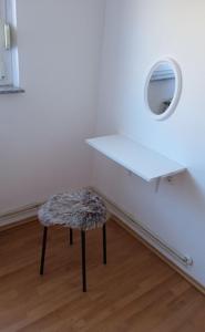 a white table and stool in a room with a mirror at Apartman Panonia in Slavonski Brod +7 photos