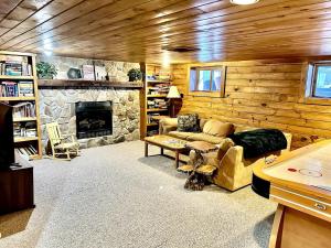 a living room with a couch and a stone fireplace at Quiet Maine Cabin Getaway in Lebanon