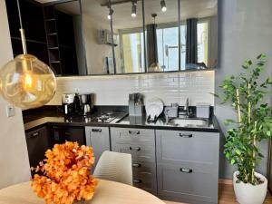 a kitchen with a sink and a table with oranges on it at Modern Studio in Catete – Close to the Metro in Rio de Janeiro +8 photos