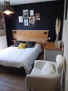 a bedroom with a bed and a chair at Les Etoiles du mont d'Uzore in Chalain-dʼUzore +39 photos