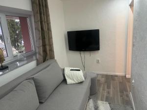 a living room with a couch and a flat screen tv at Vila zvjezda 2 in Jajce