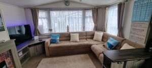 a living room with a couch and a tv at Island Escape Sandown in Sandown