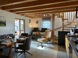 a kitchen and living room with a table and chairs at Ferienwohnung Richter in Rettenberg +31 photos