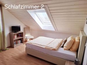 a bedroom with a bed and a skylight at Hotel Lindenhof in Rödermark