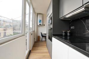 a kitchen with a black counter top and a window at Luxury loft Cassia in Rome