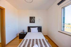 Postel nebo postele na pokoji v ubytování Zezita's Place
