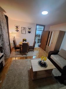 a living room with a couch and a table at Apartaman Sweet Home in Bačka Palanka +5 photos